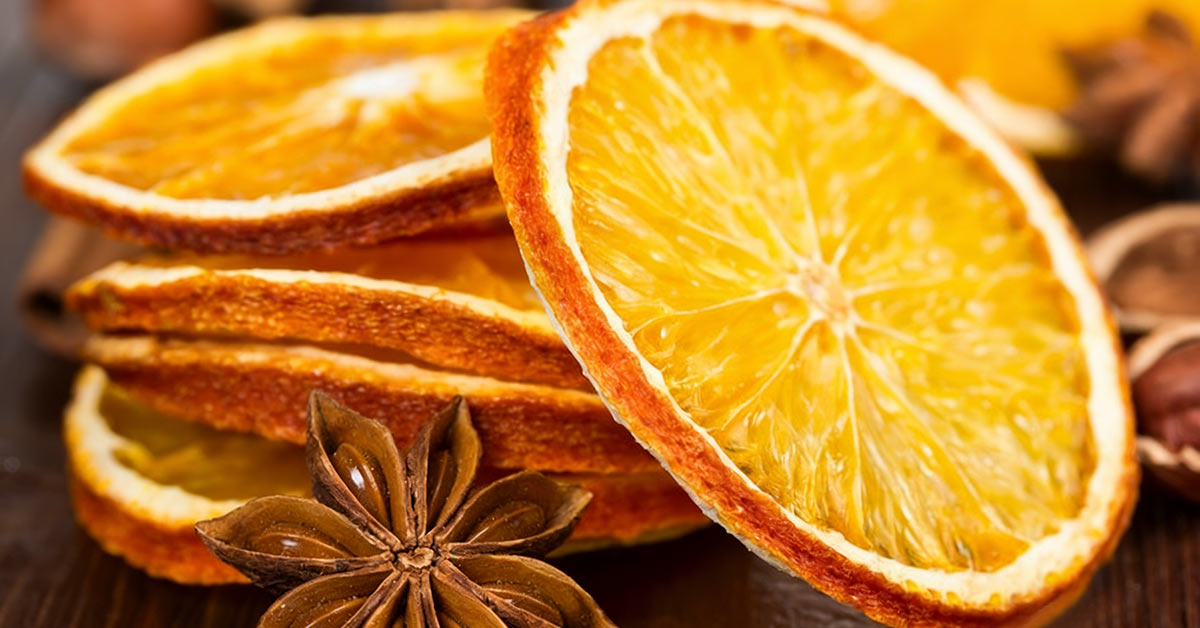Sunlit dried orange slices on natural wood – bright and organic feel